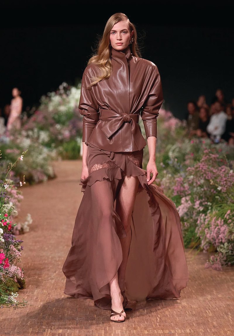 Elie Saab Spring/Summer 2027, Look 7 Model in a chocolate leather jacket and flowing skirt at Elie Saab Spring/Summer 2027